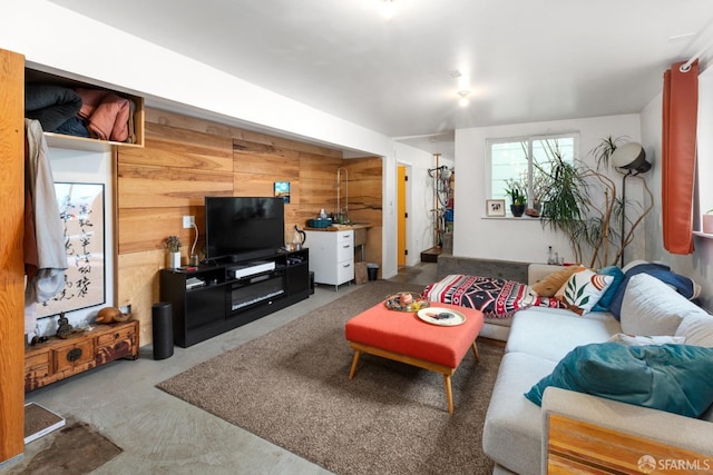 living room featuring wood walls