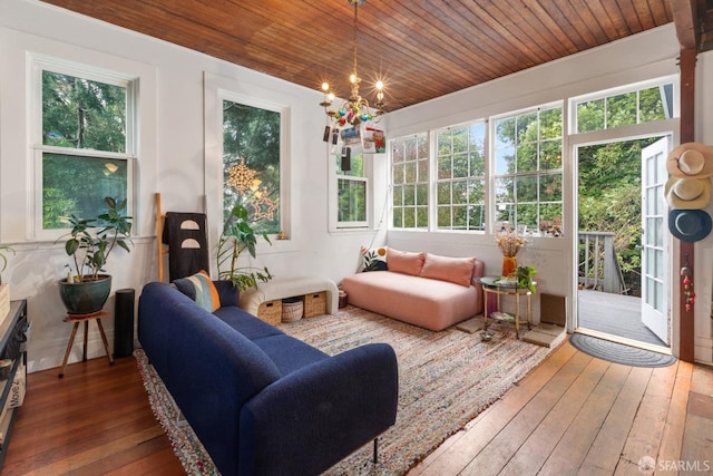 sunroom / solarium with a wealth of natural light, wood ceiling, and a notable chandelier