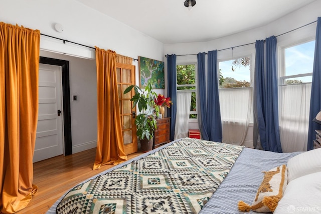 bedroom featuring light hardwood / wood-style floors and multiple windows