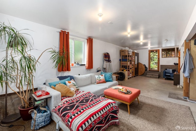 living room featuring plenty of natural light and concrete flooring