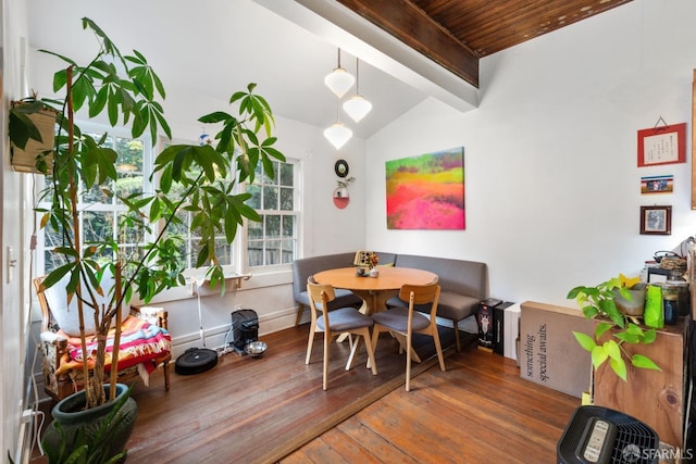 dining area with vaulted ceiling with beams and dark hardwood / wood-style flooring