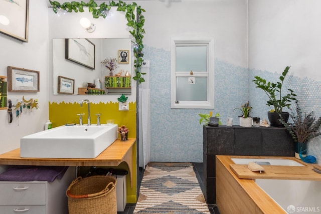 bathroom with tile patterned flooring, vanity, and tile walls