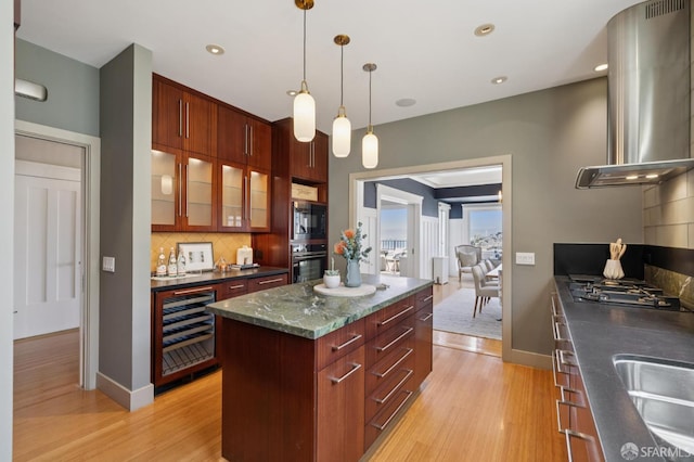1123 Greenwich St, San Francisco, CA 94109 - kitchen with beverage cooler, island exhaust hood, appliances with stainless steel finishes, light wood finished floors, and recessed lighting
