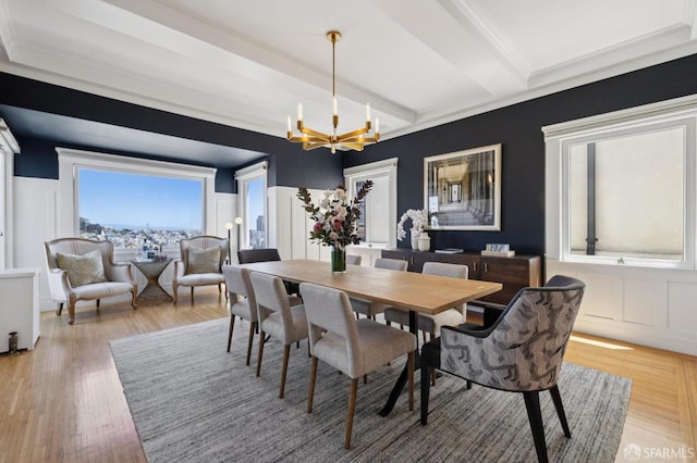 1123 Greenwich St, San Francisco, CA 94109 - dining space featuring a decorative wall, a chandelier, light wood-type flooring, beam ceiling, and wainscoting
