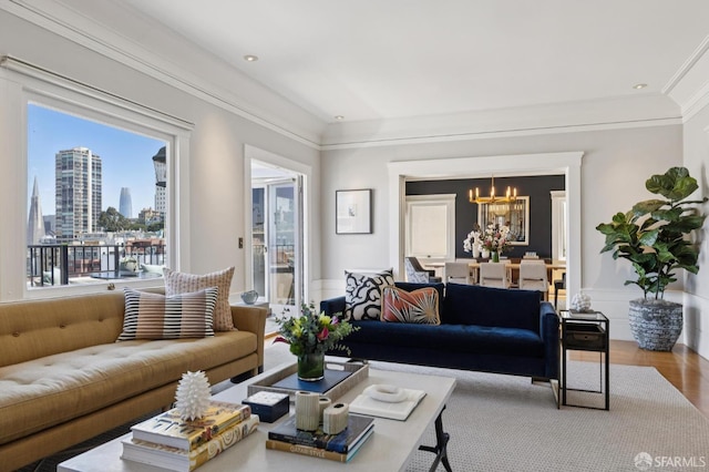 1123 Greenwich St, San Francisco, CA 94109 - living room featuring a chandelier, wainscoting, wood finished floors, crown molding, and a view of city