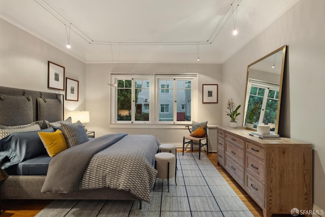 1123 Greenwich St, San Francisco, CA 94109 - bedroom featuring rail lighting, wood finished floors, and attic access