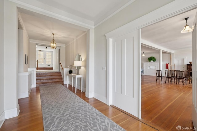 1123 Greenwich St, San Francisco, CA 94109 - entryway with hardwood / wood-style floors, a chandelier, ornamental molding, stairs, and baseboards