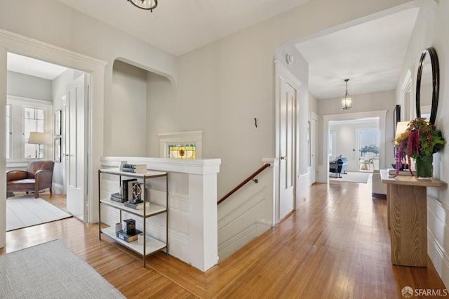 1123 Greenwich St, San Francisco, CA 94109 - hallway with a chandelier and light wood-style flooring