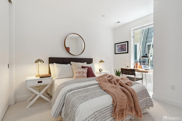 bedroom featuring light carpet