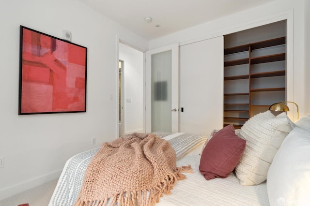 carpeted bedroom featuring a closet