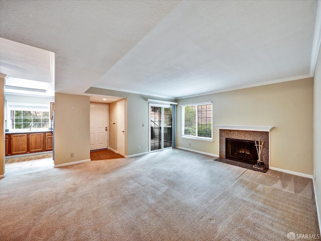 605 Canyon Oaks Dr Unit B, Oakland, CA 94605 - unfurnished living room featuring ornamental molding, light colored carpet, healthy amount of natural light, and a high end fireplace