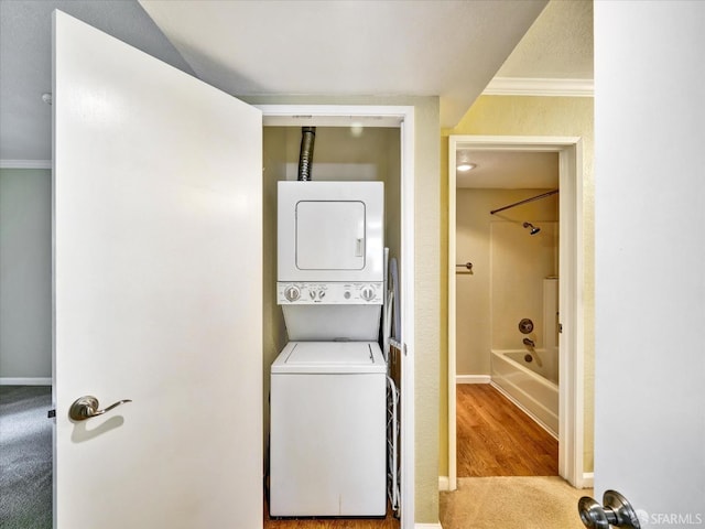 605 Canyon Oaks Dr Unit B, Oakland, CA 94605 - laundry room with estacked washer and dryer, crown molding, and carpet flooring