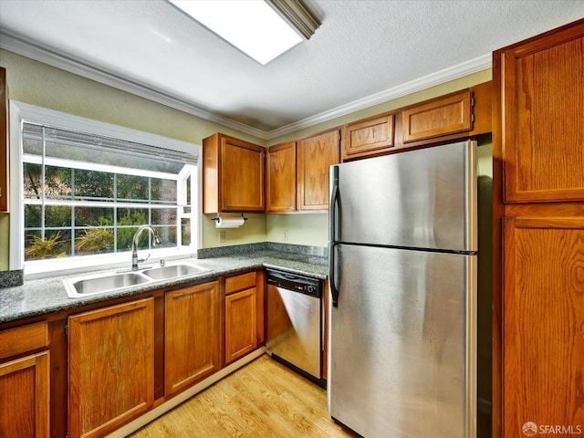 605 Canyon Oaks Dr Unit B, Oakland, CA 94605 - kitchen with stainless steel appliances, crown molding, brown cabinetry, light wood-style floors, and dark countertops