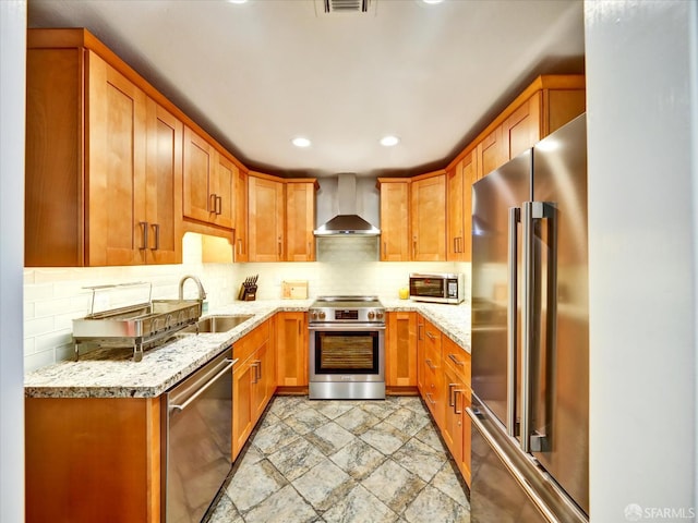 605 Canyon Oaks Dr Unit B, Oakland, CA 94605 - kitchen with stainless steel appliances, wall chimney range hood, light stone countertops, backsplash, and recessed lighting