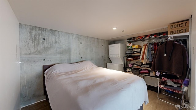 bedroom with wood-type flooring and a closet