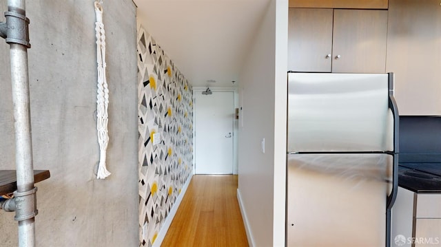 kitchen featuring light hardwood / wood-style floors and stainless steel refrigerator