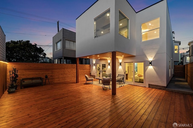 deck at dusk with an outdoor living space