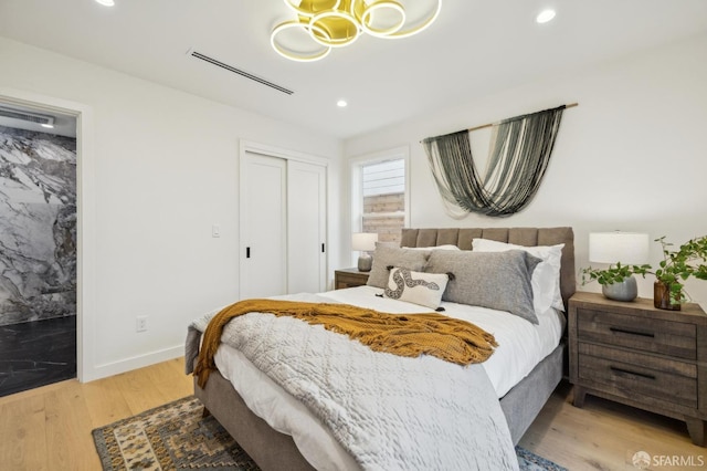 bedroom featuring a closet and light wood-type flooring