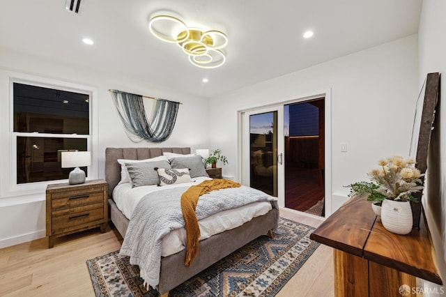 bedroom with light wood-style floors, access to exterior, visible vents, and recessed lighting