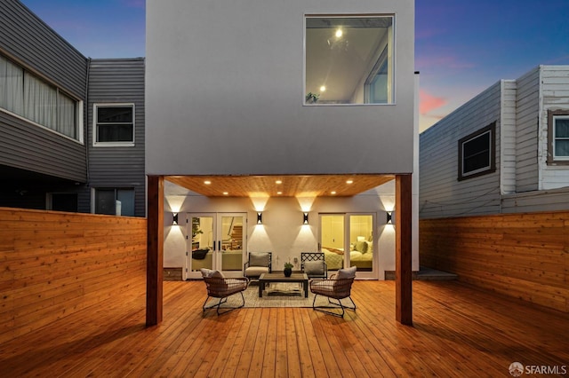 deck at dusk with an outdoor hangout area