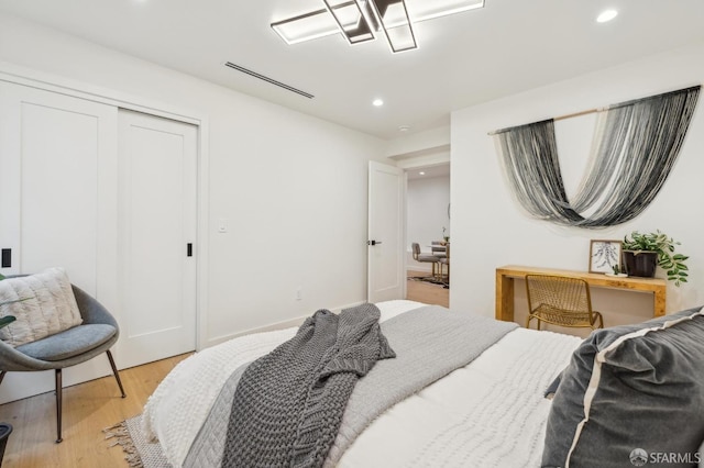 bedroom featuring light hardwood / wood-style floors and a closet