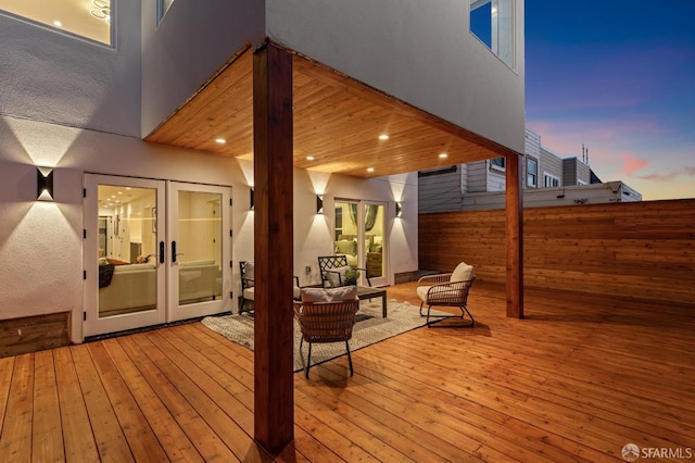 wooden deck featuring fence, outdoor lounge area, and french doors