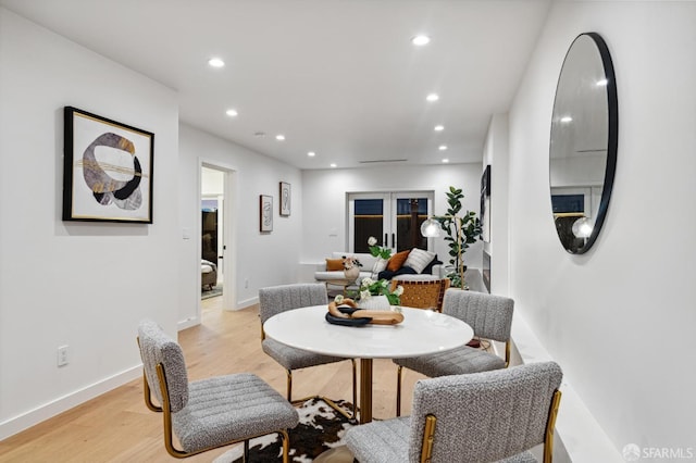 dining space featuring light wood-style flooring, baseboards, and recessed lighting