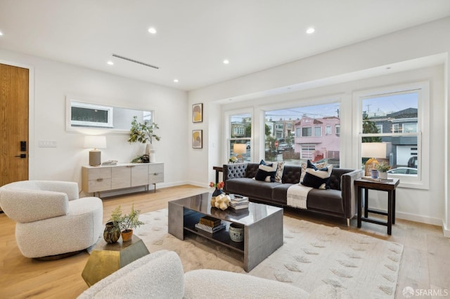 living room featuring a healthy amount of sunlight and light wood-type flooring