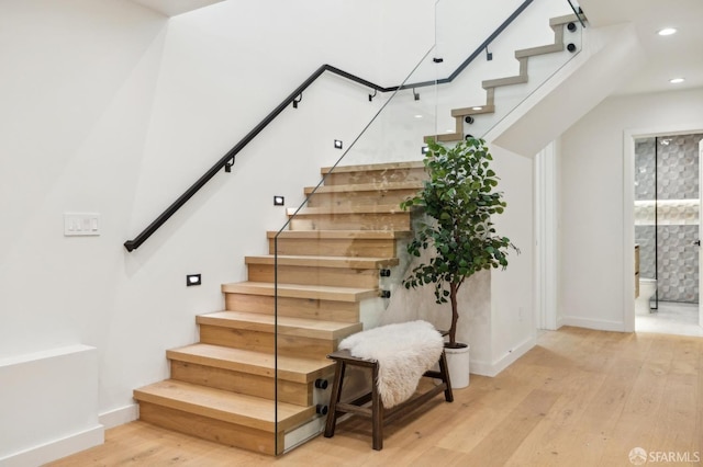 stairs with hardwood / wood-style flooring