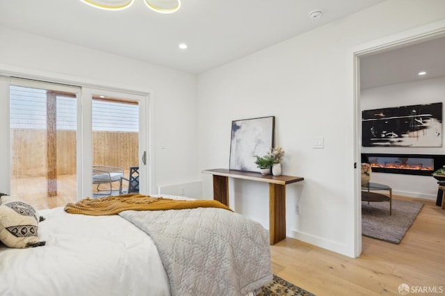 bedroom with light hardwood / wood-style flooring and access to outside