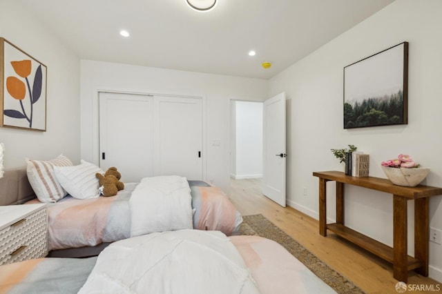 bedroom featuring light hardwood / wood-style flooring and a closet