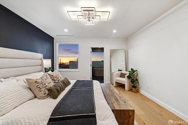 bedroom with baseboards, wood finished floors, and recessed lighting