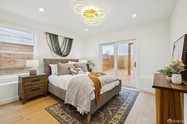 bedroom featuring access to outside and light hardwood / wood-style floors