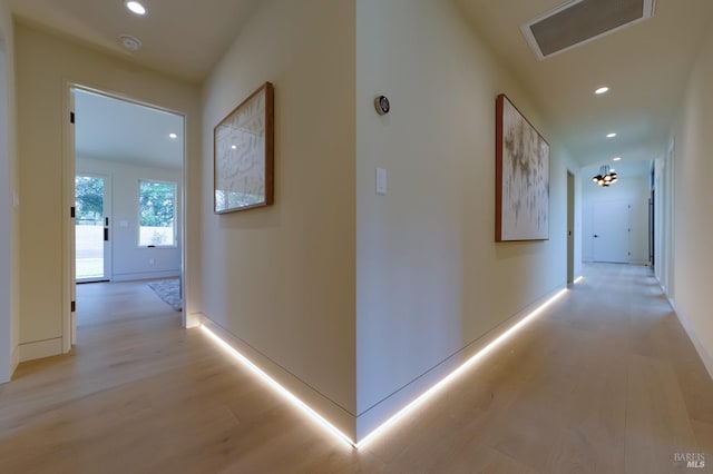 corridor with light hardwood / wood-style flooring