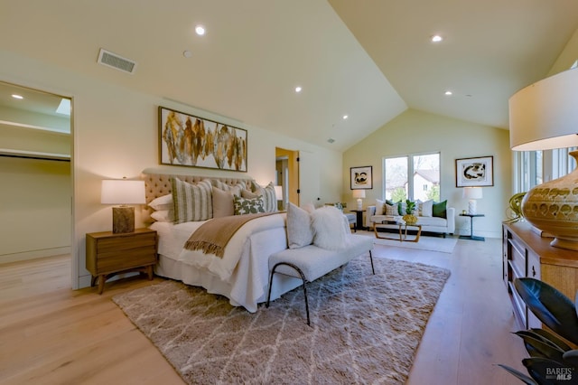 bedroom featuring lofted ceiling and light wood-type flooring