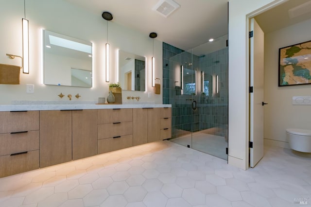 bathroom with vanity, a shower with door, tile patterned floors, and toilet