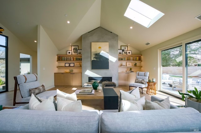 living room featuring a fireplace, lofted ceiling with skylight, and light wood-type flooring