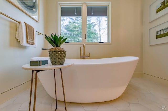 bathroom with a bathing tub and tile patterned flooring