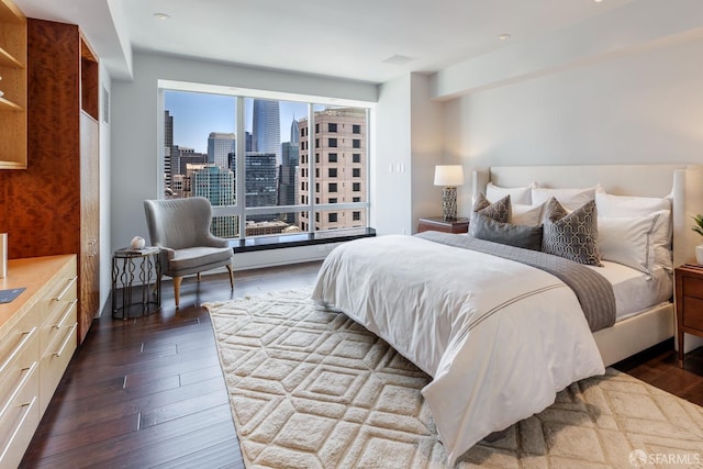 bedroom with dark hardwood / wood-style floors