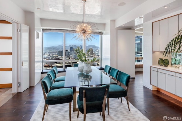 dining room featuring a mountain view, dark hardwood / wood-style floors, and a notable chandelier