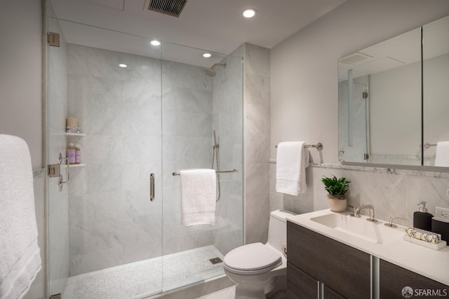 bathroom featuring walk in shower, tasteful backsplash, toilet, vanity, and tile walls