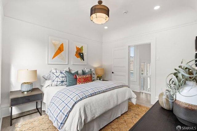 bedroom featuring baseboards, recessed lighting, and light wood-style flooring