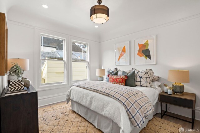 bedroom with baseboards, recessed lighting, and wood finished floors