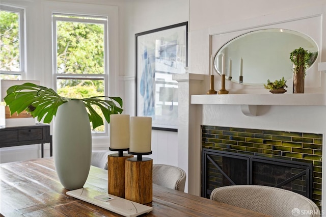 dining room with a decorative wall and a fireplace