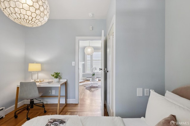 1250 Vallejo St Unit 7, San Francisco, CA 94109 - bedroom with an office area, a baseboard radiator, and wood finished floors