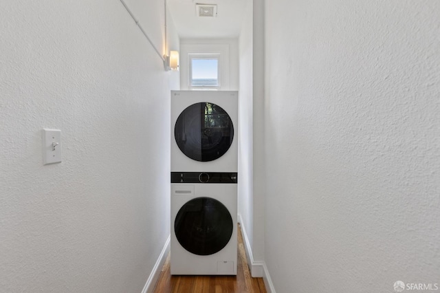 1250 Vallejo St Unit 7, San Francisco, CA 94109 - laundry room featuring stacked washer / dryer and wood finished floors