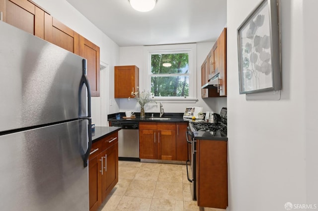1250 Vallejo St Unit 7, San Francisco, CA 94109 - kitchen featuring appliances with stainless steel finishes, under cabinet range hood, dark countertops, brown cabinets, and light tile patterned floors