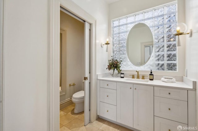 bathroom featuring vanity, toilet, and tile patterned flooring