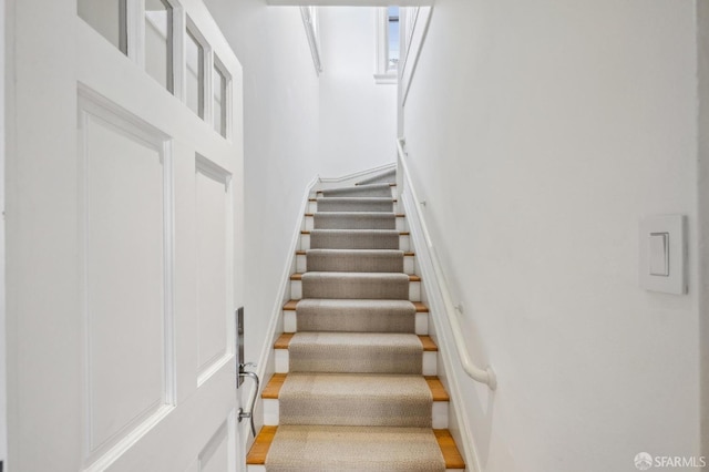 stairway with hardwood / wood-style flooring