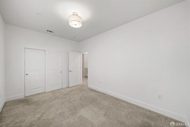 unfurnished bedroom featuring a closet and carpet